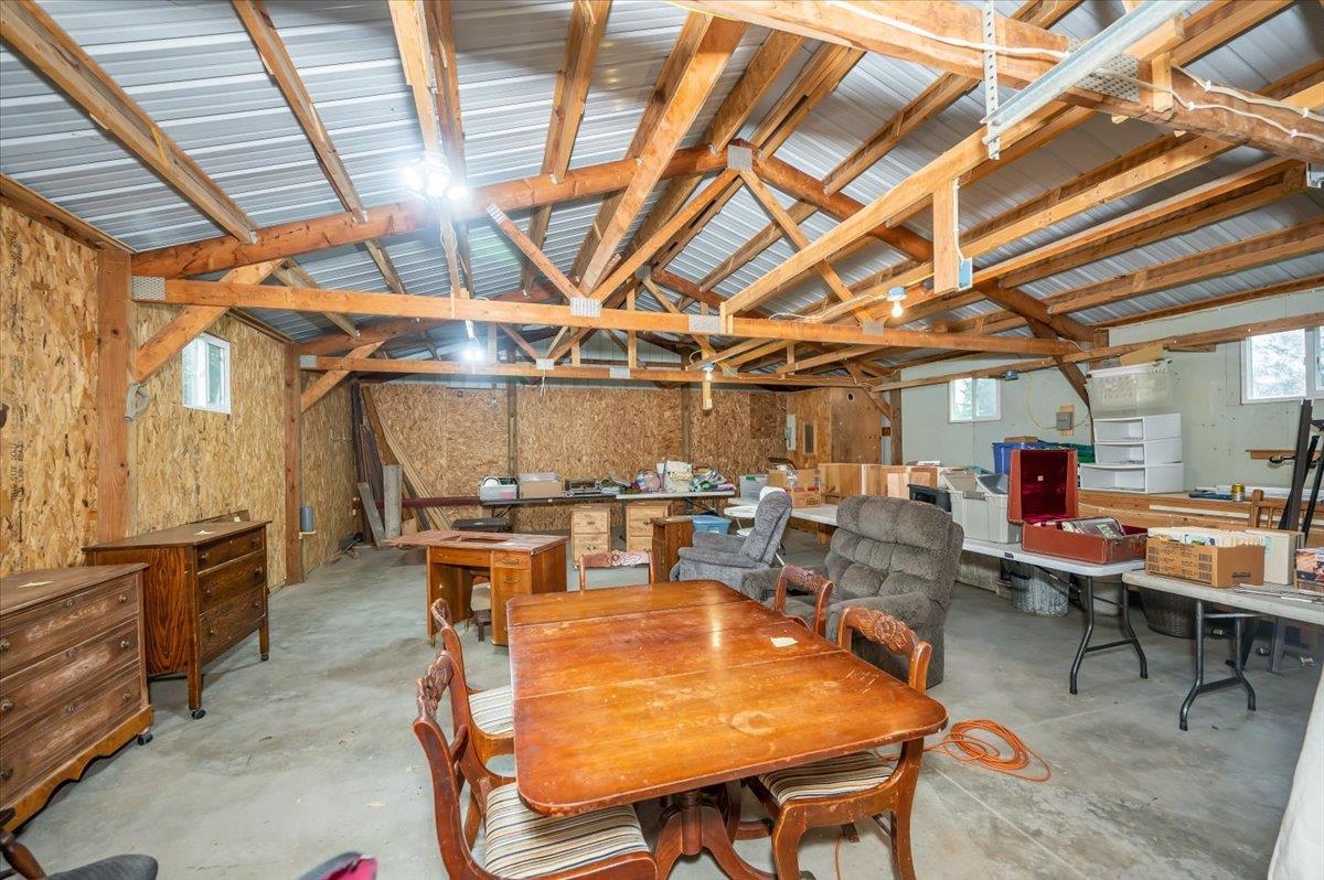 404 Alcohol Road Wrenshall, MN 55797 - Photo 29 of 32 Dining room featuring unfinished concrete floors, healthy amount of natural light, and lofted ceiling