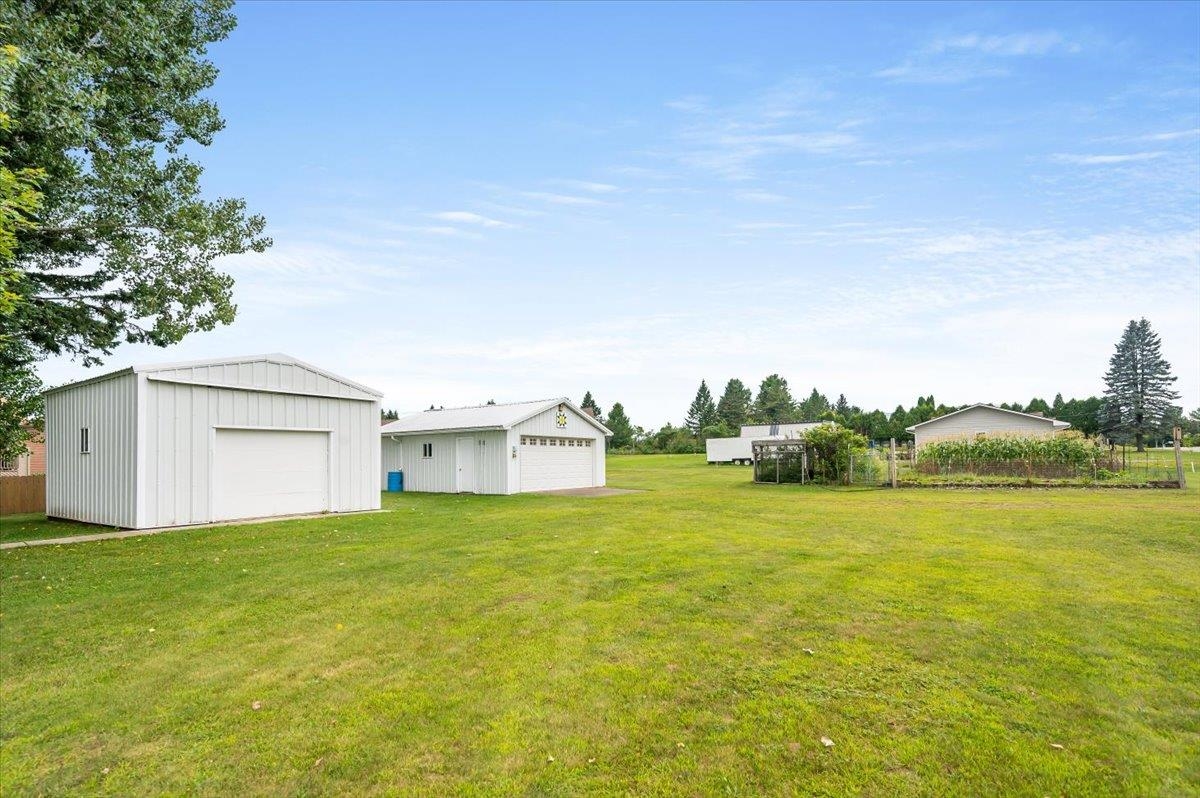 404 Alcohol Road Wrenshall, MN 55797 - Photo 31 of 32 View of yard featuring a garage and an outdoor structure