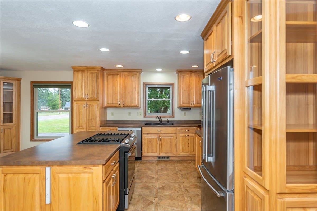 404 Alcohol Road Wrenshall, MN 55797 - Photo 8 of 32 Kitchen featuring glass insert cabinets, stainless steel appliances, dark countertops, a center island, and recessed lighting