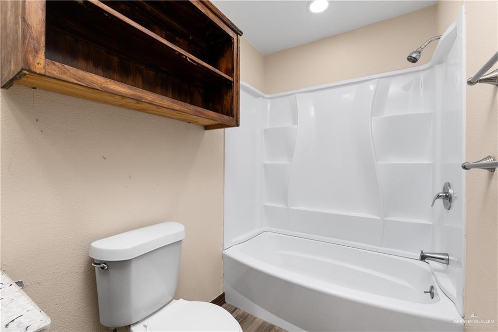 310 North Arroyo Boulevard Rio Hondo, TX 78583 - Photo 15 of 31 a white toilet sitting next to a bath tub