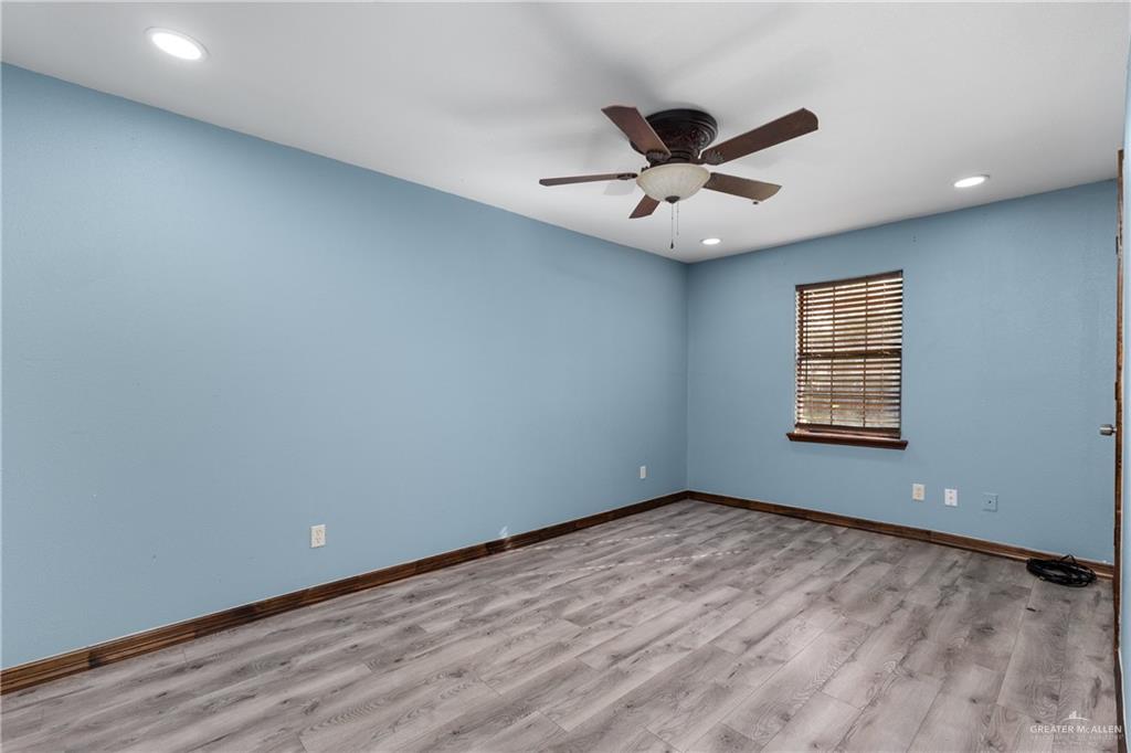 310 North Arroyo Boulevard Rio Hondo, TX 78583 - Photo 16 of 31 wooden floor in an empty room with a window