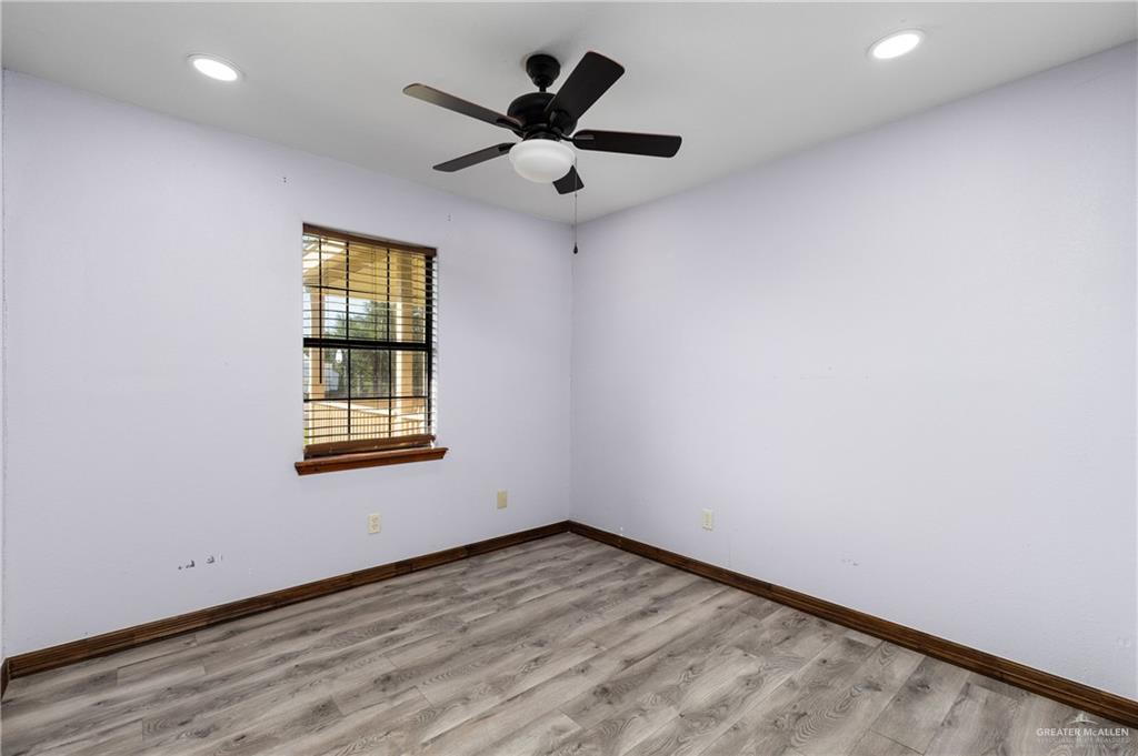 310 North Arroyo Boulevard Rio Hondo, TX 78583 - Photo 17 of 31 an empty room with wooden floor and windows