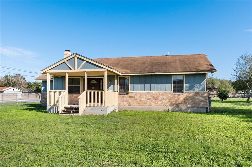 310 North Arroyo Boulevard Rio Hondo, TX 78583 - Photo 2 of 31 a front view of a house with a yard table and chairs