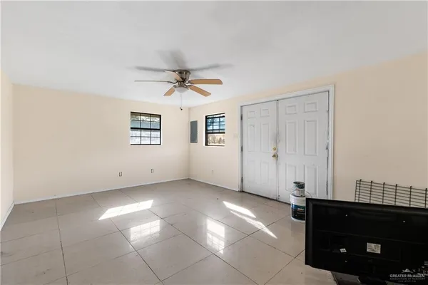 a view of a livingroom with a ceiling fan and window