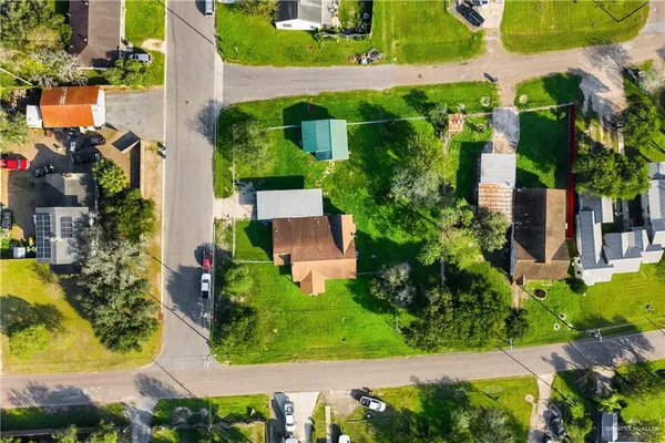 an aerial view of residential houses with outdoor space and swimming pool