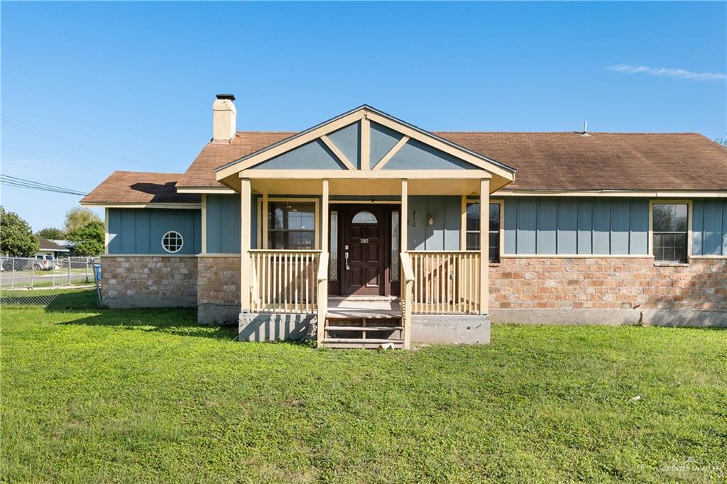 310 North Arroyo Boulevard Rio Hondo, TX 78583 - Photo 3 of 31 a front view of a house with a yard