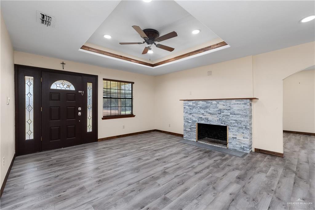 310 North Arroyo Boulevard Rio Hondo, TX 78583 - Photo 4 of 31 a view of an empty room with wooden floor fireplace and a window