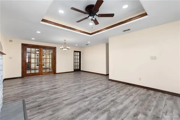 a view of a livingroom with a ceiling fan and wooden floor