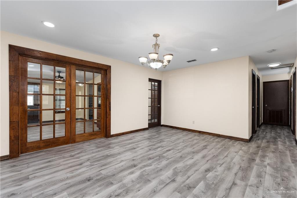 310 North Arroyo Boulevard Rio Hondo, TX 78583 - Photo 6 of 31 a view of an empty room with a window and wooden floor