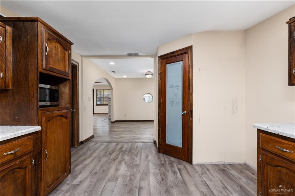 310 North Arroyo Boulevard Rio Hondo, TX 78583 - Photo 9 of 31 a view of a hallway with wooden floor and closet