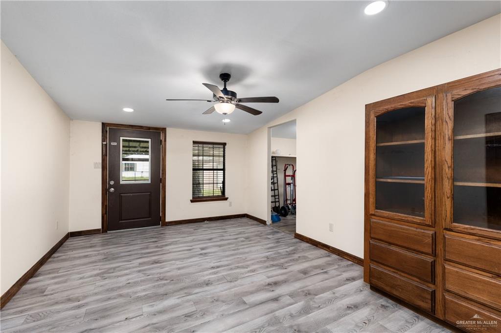 310 North Arroyo Boulevard Rio Hondo, TX 78583 - Photo 10 of 31 wooden floor in an empty room with a window