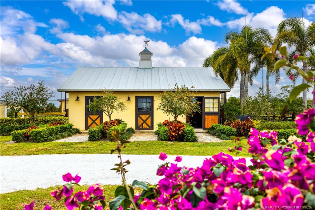 7625 Polo Square Vero Beach, FL 32968 - Photo 2 of 35 a front view of house with yard and flowers