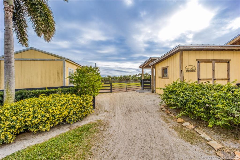 7625 Polo Square Vero Beach, FL 32968 - Photo 30 of 35 a front view of a house with garden