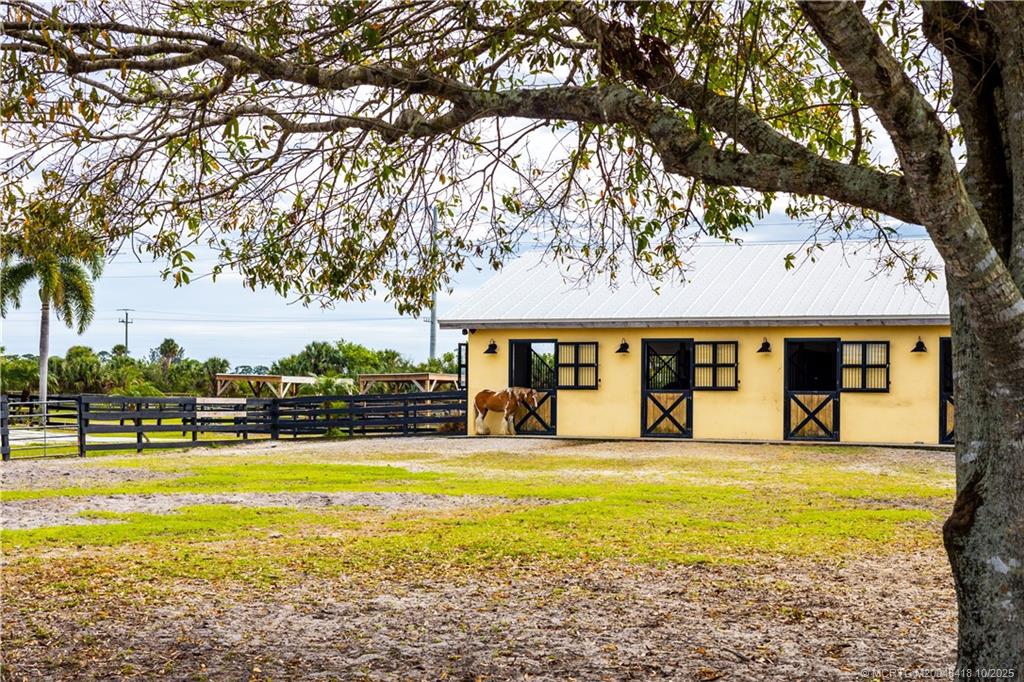 7625 Polo Square Vero Beach, FL 32968 - Photo 10 of 35 a front view of a building with swimming pool and trees