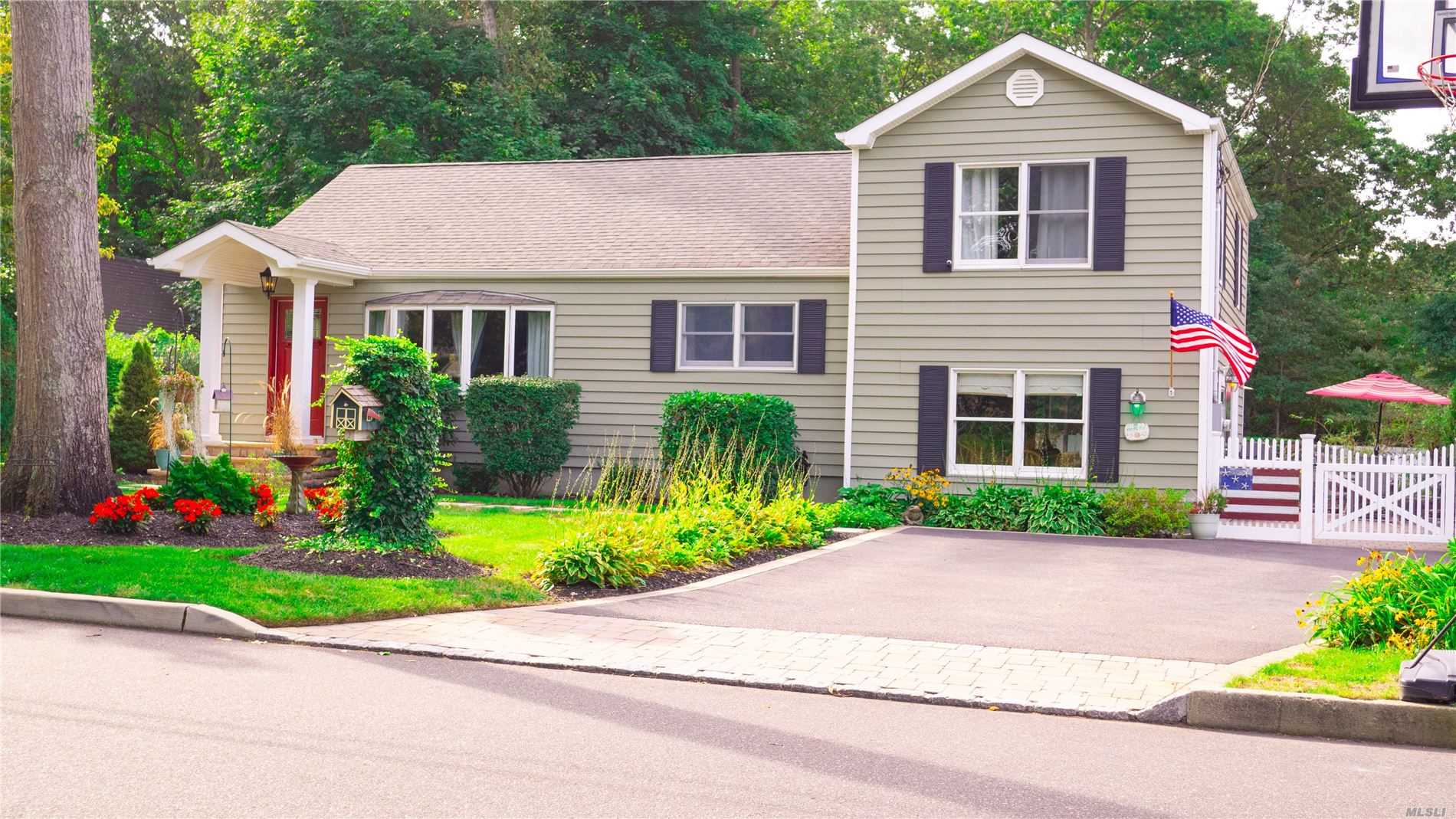 16 Nimitz Road St. James, NY 11780 - Photo 1 of 1 a front view of a house with a yard and potted plants