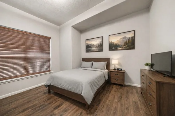 a bedroom with a bed and a dresser