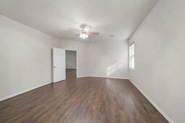 a spacious bathroom with a shower a sink and a mirror