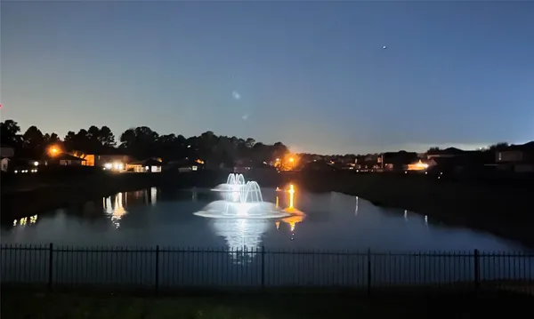 a view of a lake with houses in the background