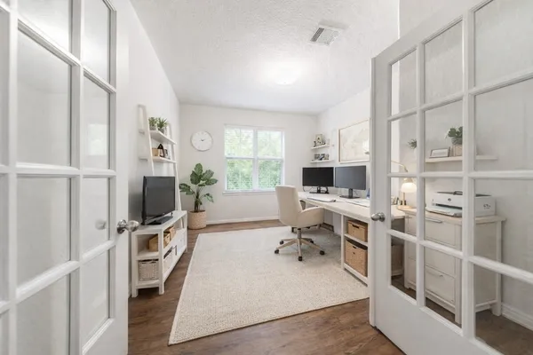 a living room with furniture fireplace and a large window