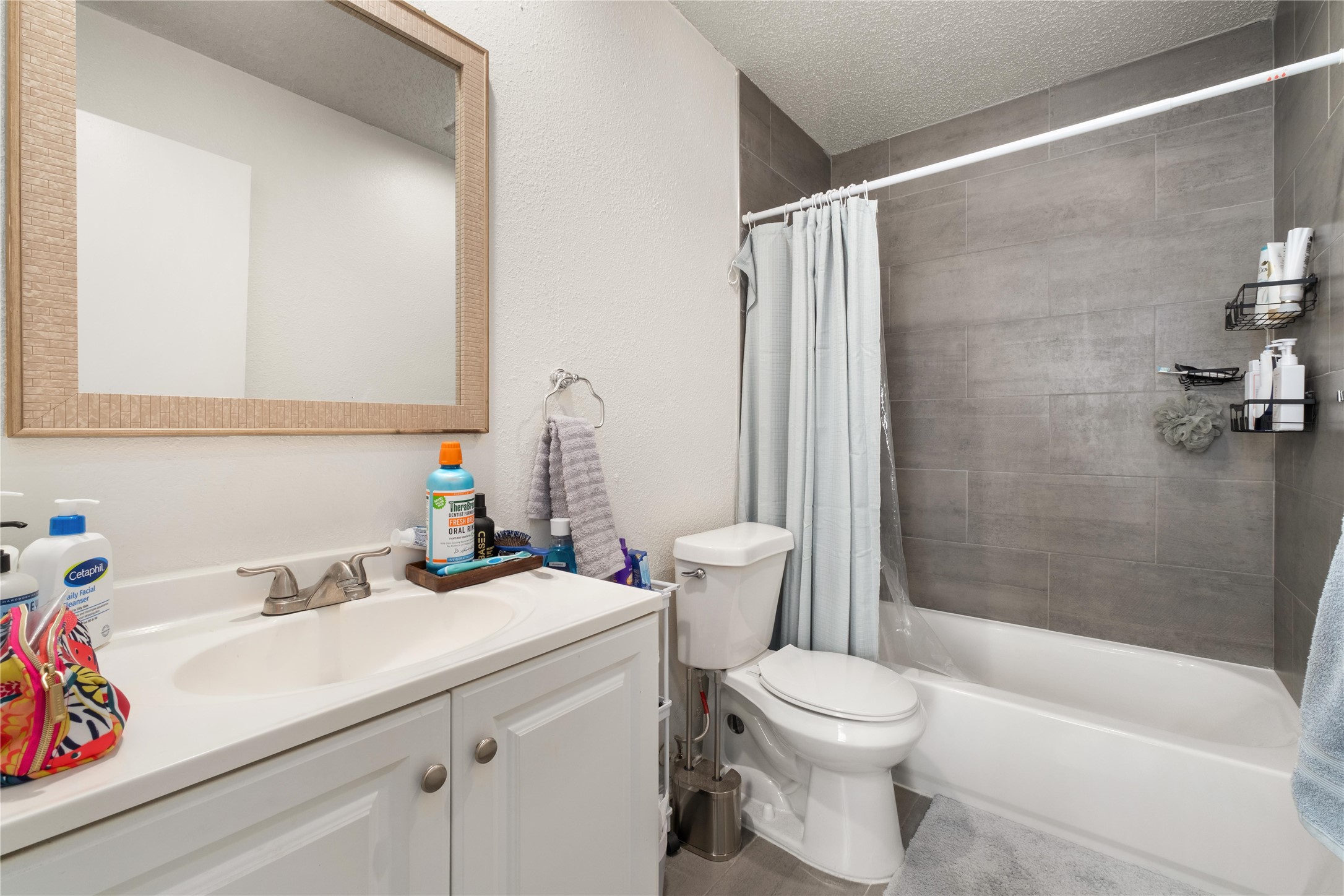 2409 Leon Street, Unit 307 Austin, TX 78705 - Photo 16 of 23 a bathroom with a sink a toilet and shower
