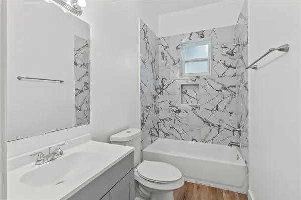 a bathroom with a sink toilet and shower