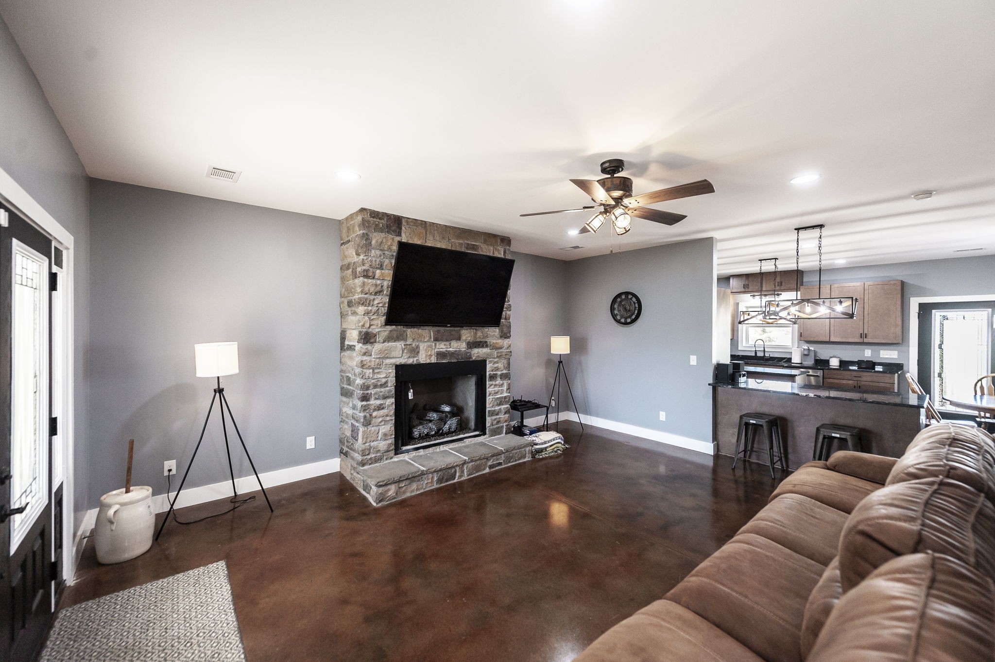 223 Cedar Hill Road Adams, TN 37010 - Photo 16 of 51 a living room with furniture a fireplace and a flat screen tv