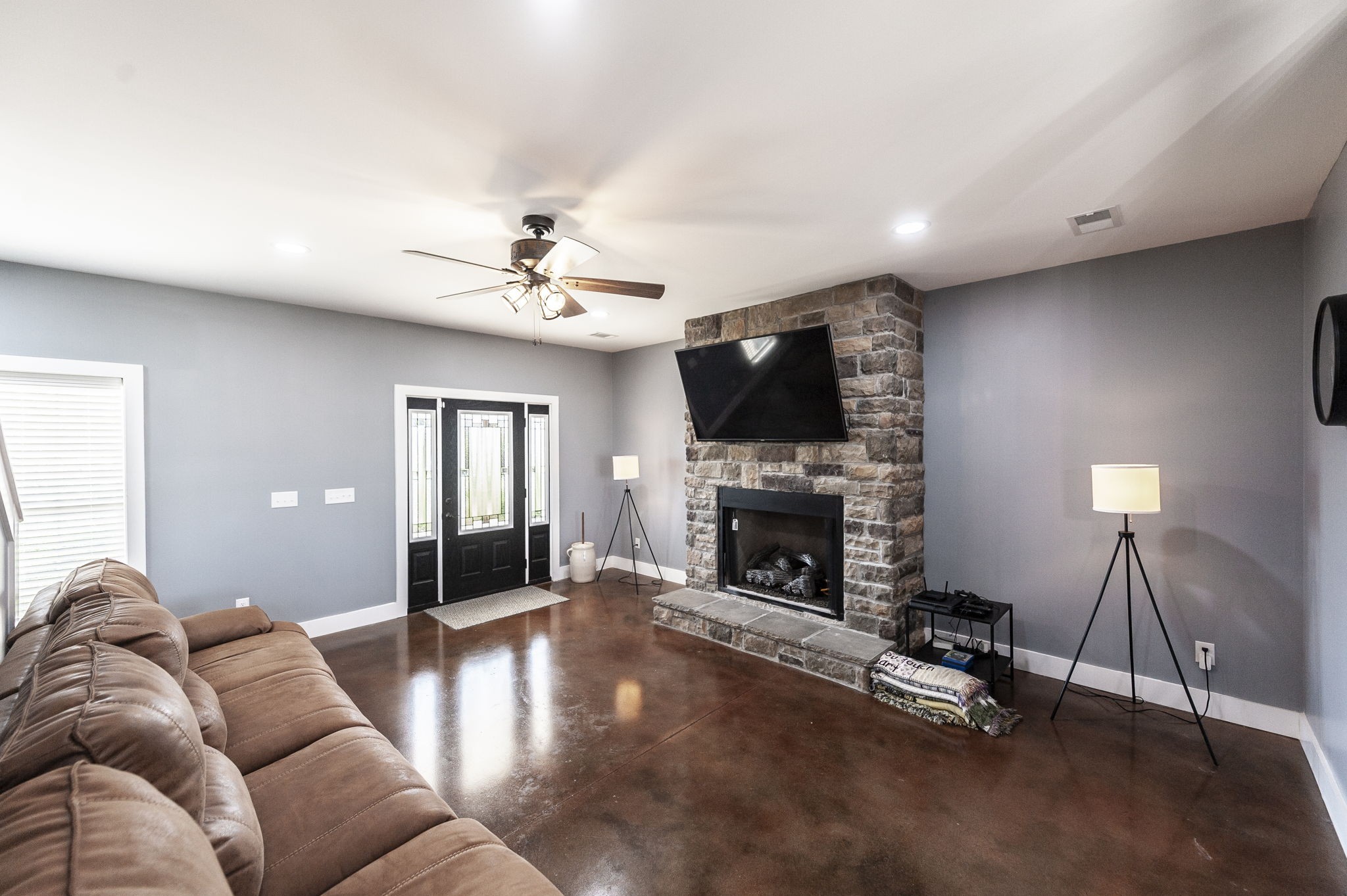 223 Cedar Hill Road Adams, TN 37010 - Photo 17 of 51 a living room with furniture a fireplace and a flat screen tv