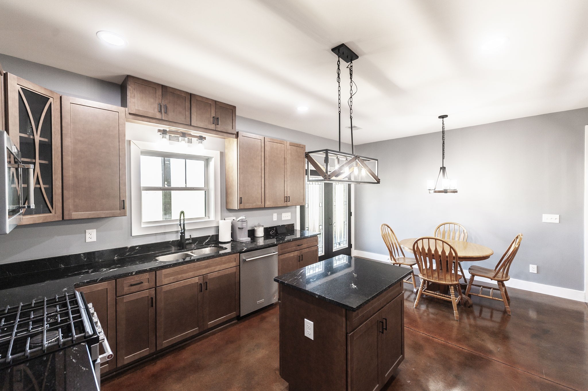 223 Cedar Hill Road Adams, TN 37010 - Photo 25 of 51 a kitchen with stainless steel appliances granite countertop a sink a stove and chairs