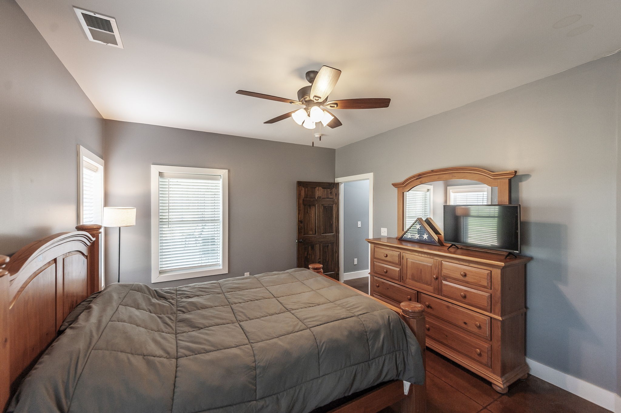 223 Cedar Hill Road Adams, TN 37010 - Photo 30 of 51 a bedroom with a bed and a dresser with mirror