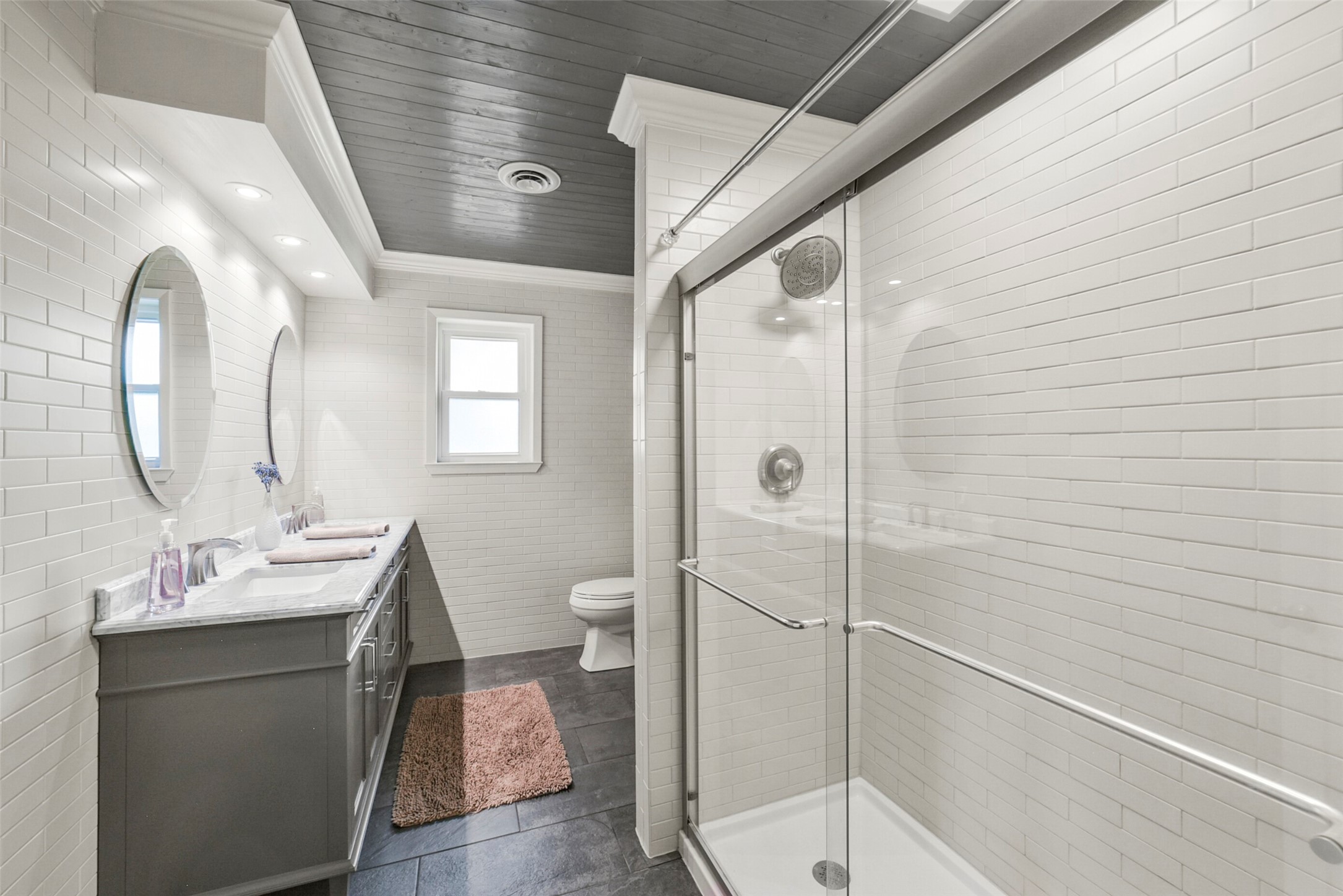 10313 South Williams Road Conroe, TX 77303 - Photo 31 of 48 Hall bathroom with paneled ceiling, gorgeous tile, and double sink.