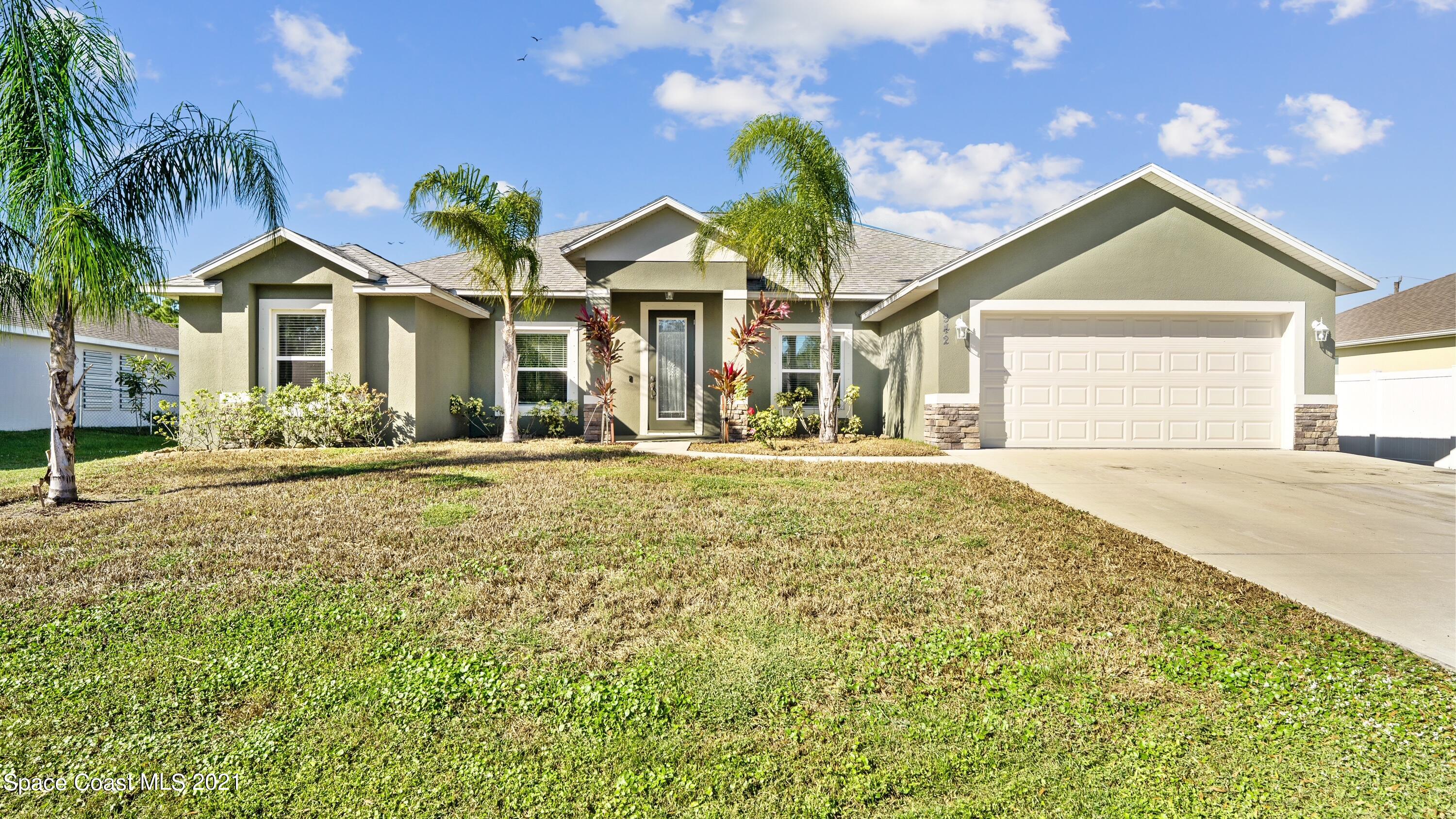 942 Carver Road Southeast Palm Bay, FL 32909 - Photo 3 of 26 a front view of a house with a yard