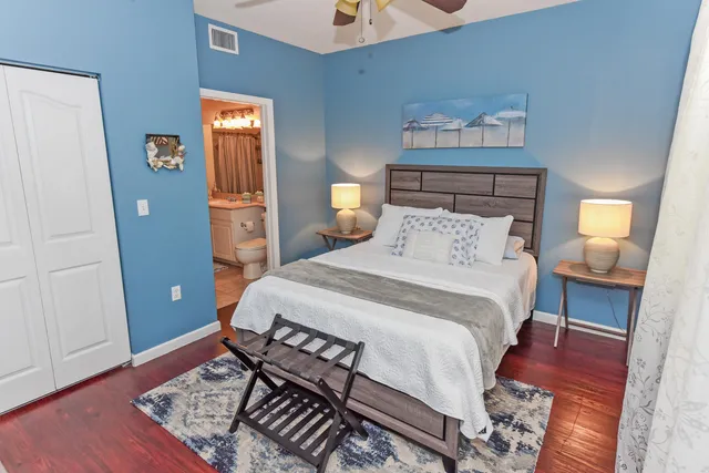 a bedroom with a bed and wooden floor