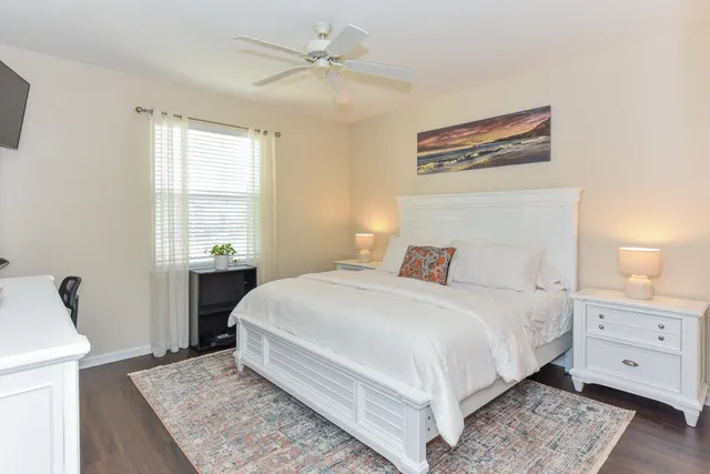 a bedroom with a large bed and a window