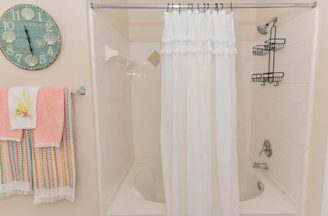 a bathroom with a bathtub and shower