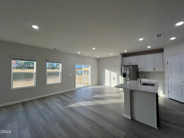 an empty room with a empty space and windows