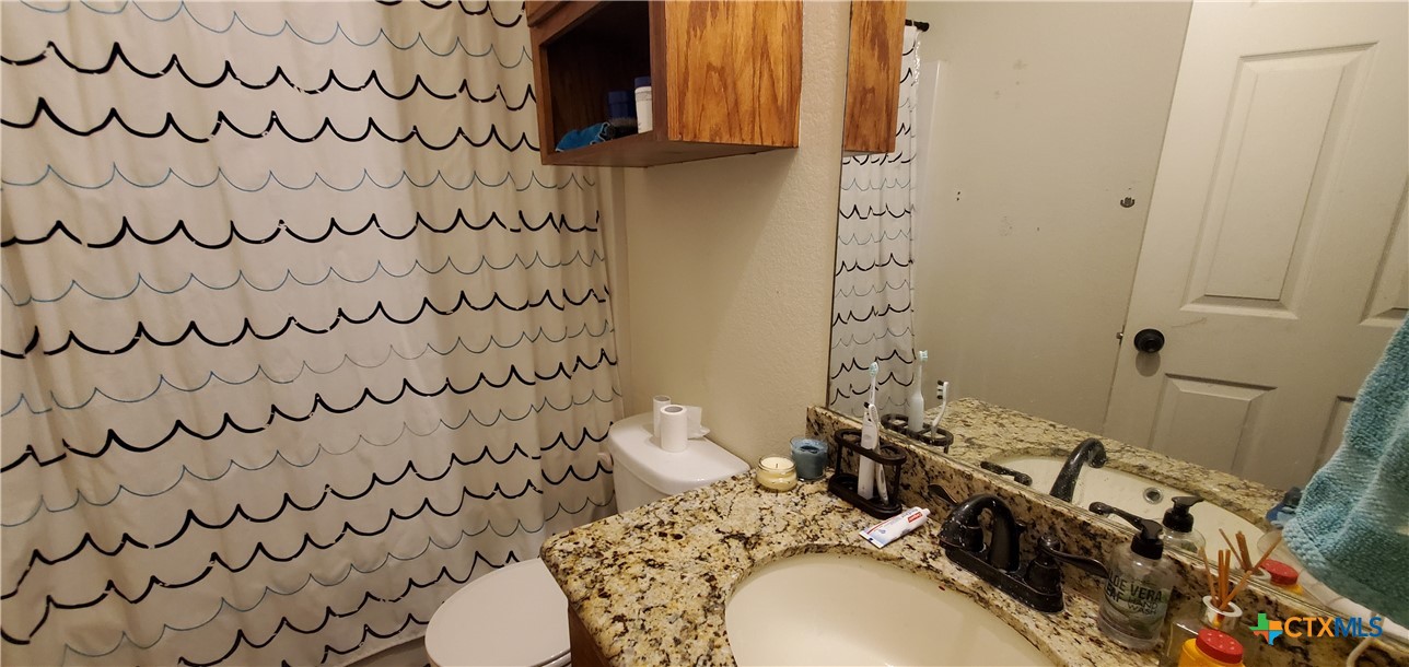2201 Valley Forge Avenue Temple, TX 76504 - Photo 13 of 15 a bathroom with a sink and a toilet