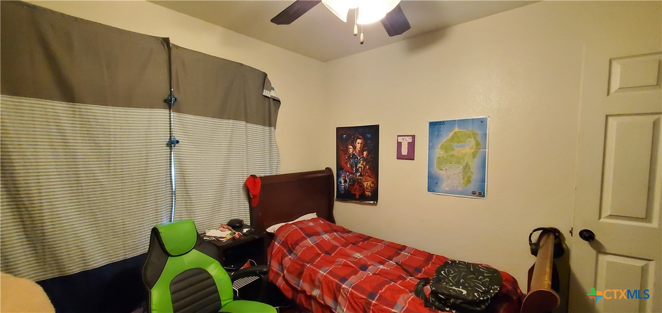 2201 Valley Forge Avenue Temple, TX 76504 - Photo 14 of 15 a bedroom with a bed and a chandelier