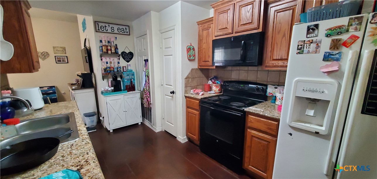 2201 Valley Forge Avenue Temple, TX 76504 - Photo 5 of 15 a kitchen with stainless steel appliances granite countertop a stove and a refrigerator