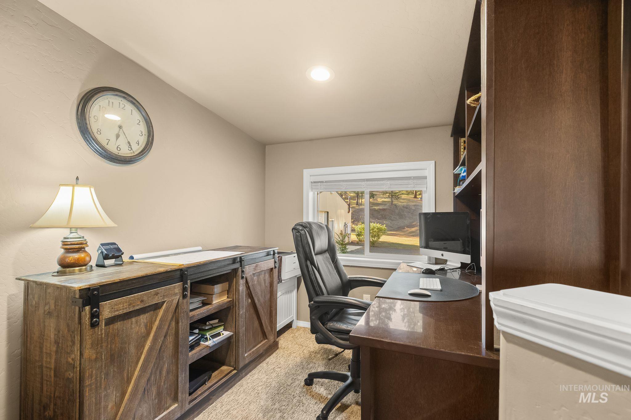 435 River Pointe Lane Lenore, ID 83541 - Photo 15 of 50 Dedicated office space featuring a built-in wood-finish desk, integrated shelving, and a window providing natural light