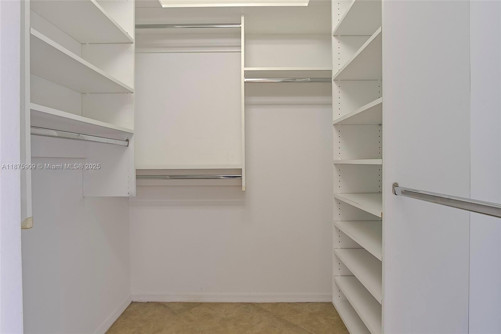 8658 Vía Reale, Unit 3 Boca Raton, FL 33496 - Photo 14 of 39 a view of walk in closet with empty racks
