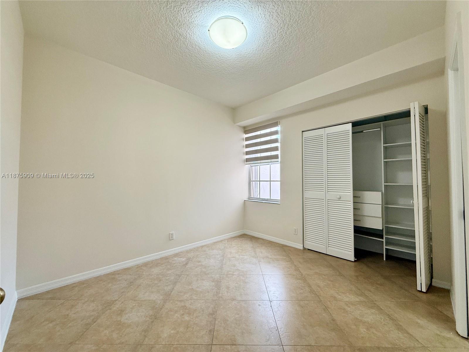 8658 Vía Reale, Unit 3 Boca Raton, FL 33496 - Photo 16 of 39 an empty room with furniture and closet