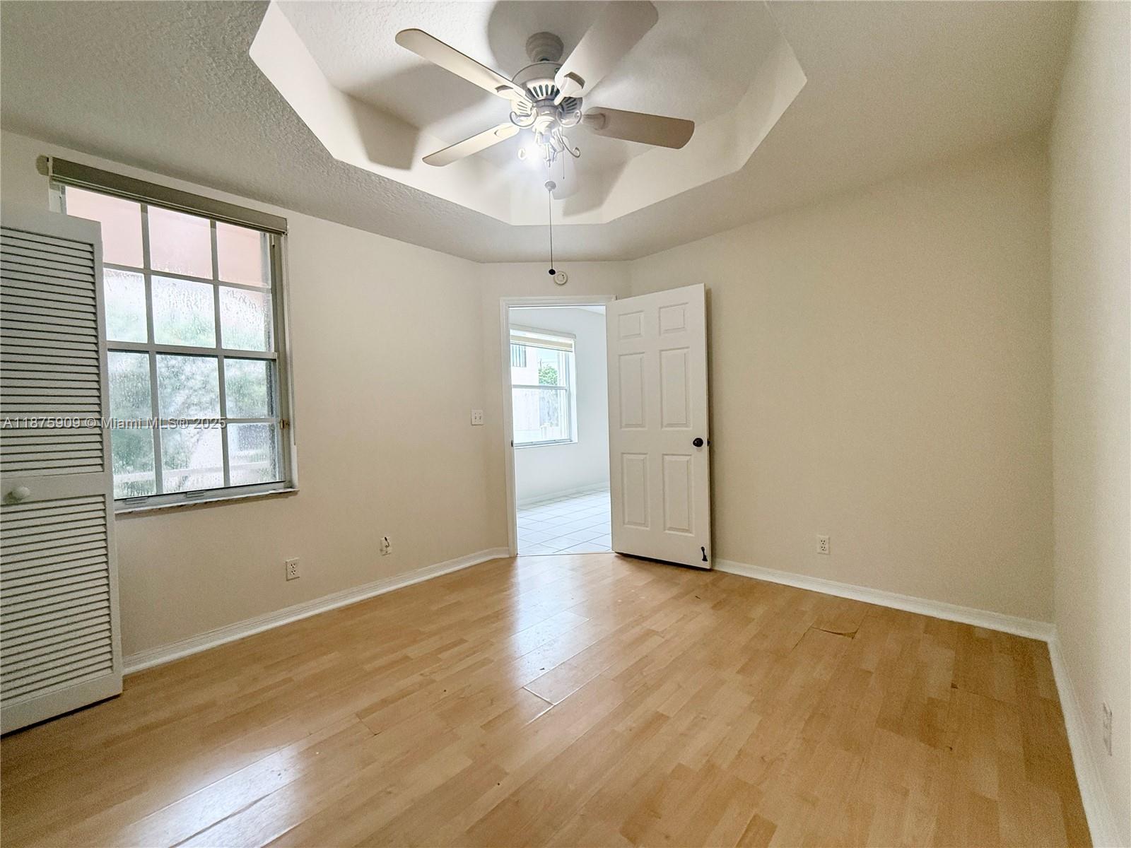 8658 Vía Reale, Unit 3 Boca Raton, FL 33496 - Photo 20 of 39 wooden floor in an empty room with a window