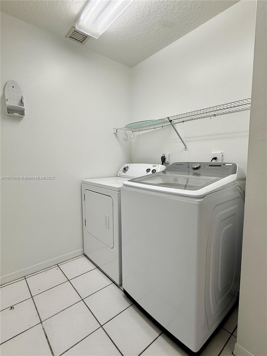 8658 Vía Reale, Unit 3 Boca Raton, FL 33496 - Photo 24 of 39 a utility room with dryer and washer