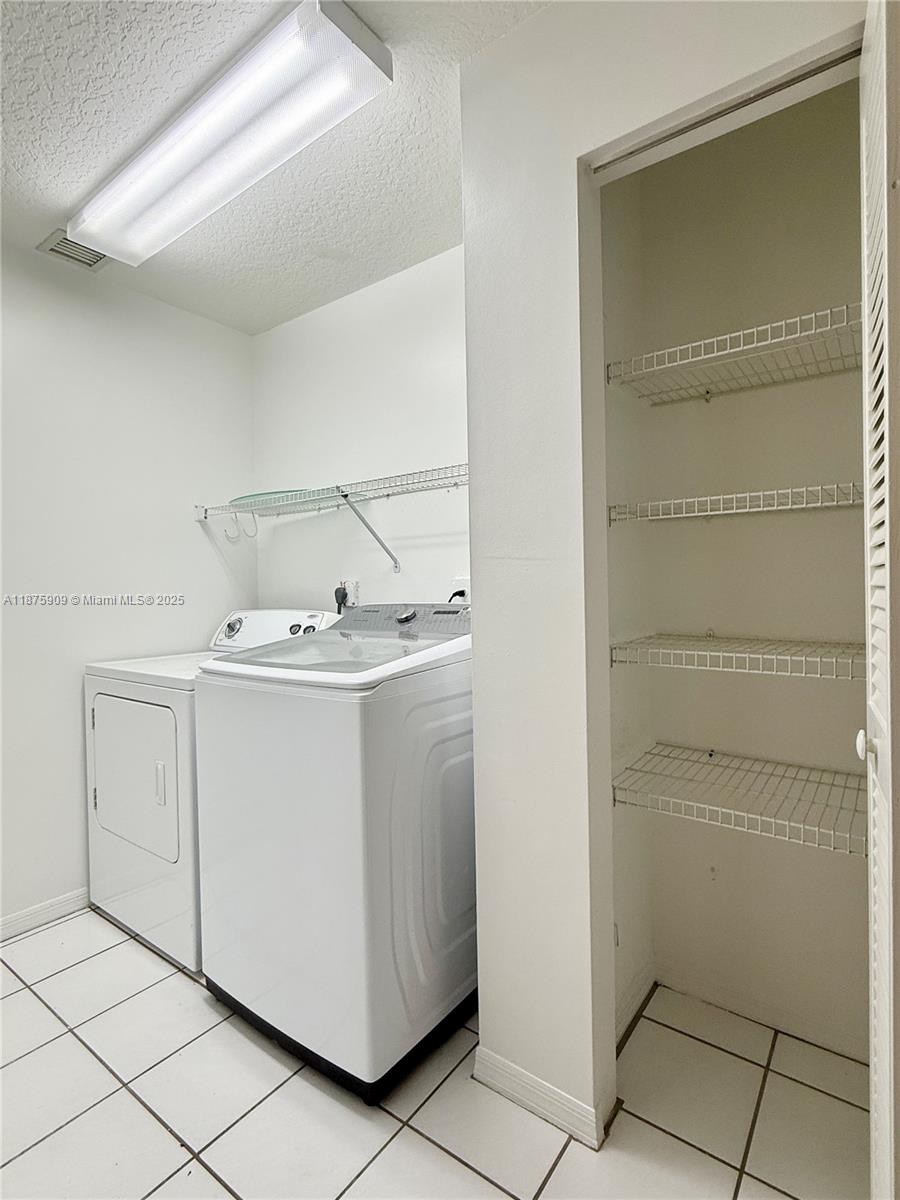 8658 Vía Reale, Unit 3 Boca Raton, FL 33496 - Photo 25 of 39 a utility room with cabinets