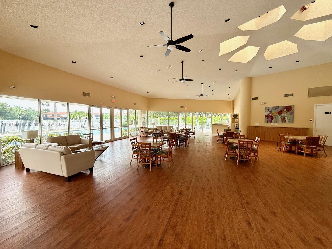 8658 Vía Reale, Unit 3 Boca Raton, FL 33496 - Photo 34 of 39 a living room with lots of furniture and a large window