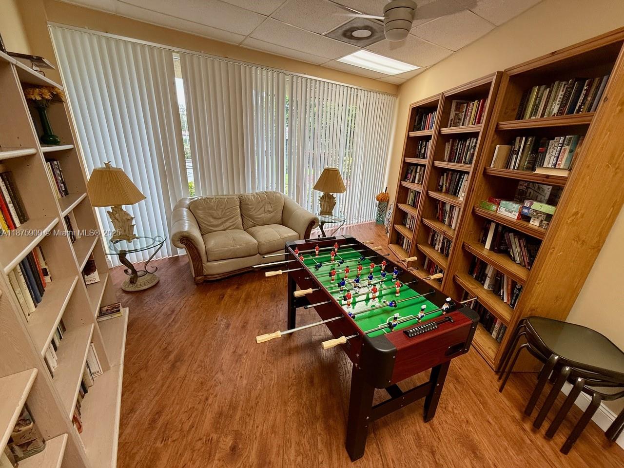 8658 Vía Reale, Unit 3 Boca Raton, FL 33496 - Photo 35 of 39 a living room with furniture and a book shelf
