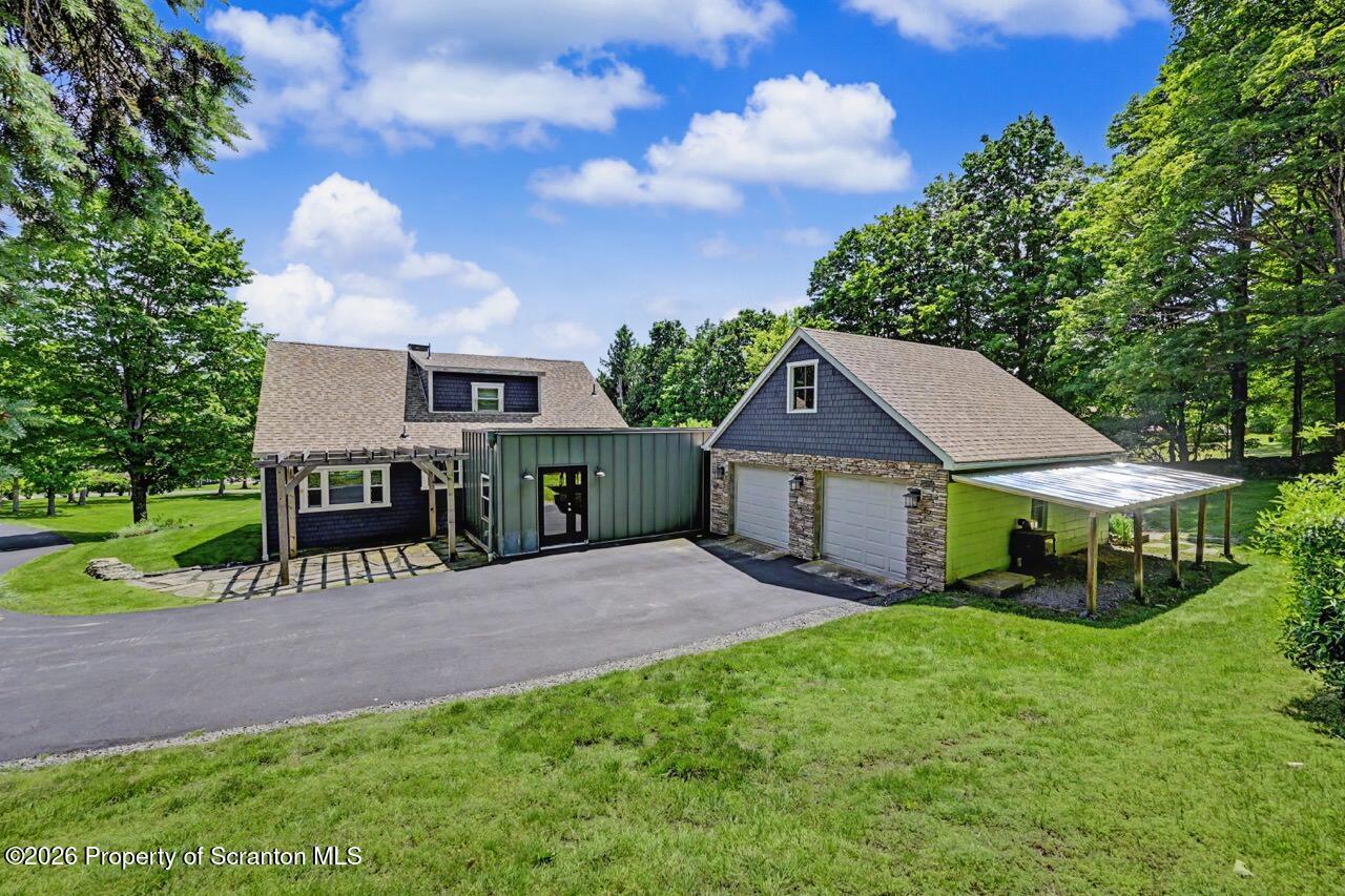 457 Craig Road Dalton, PA 18414 - Photo 109 of 114 a view of a house with a yard and a large tree