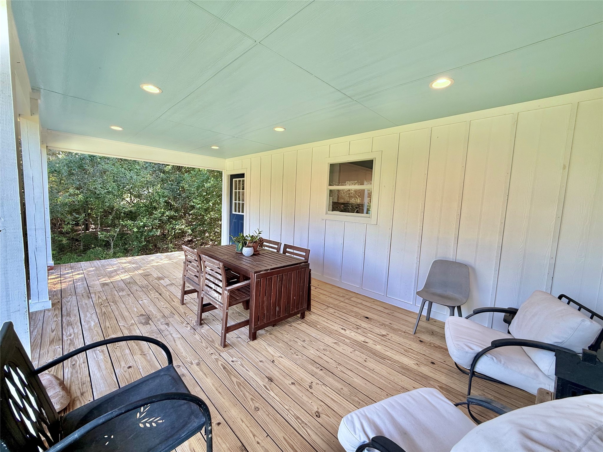 739 Pleasant Grove Road Elgin, TX 78621 - Photo 22 of 29 Covered porch with wood-finish decking, light blue ceiling, and recessed lighting