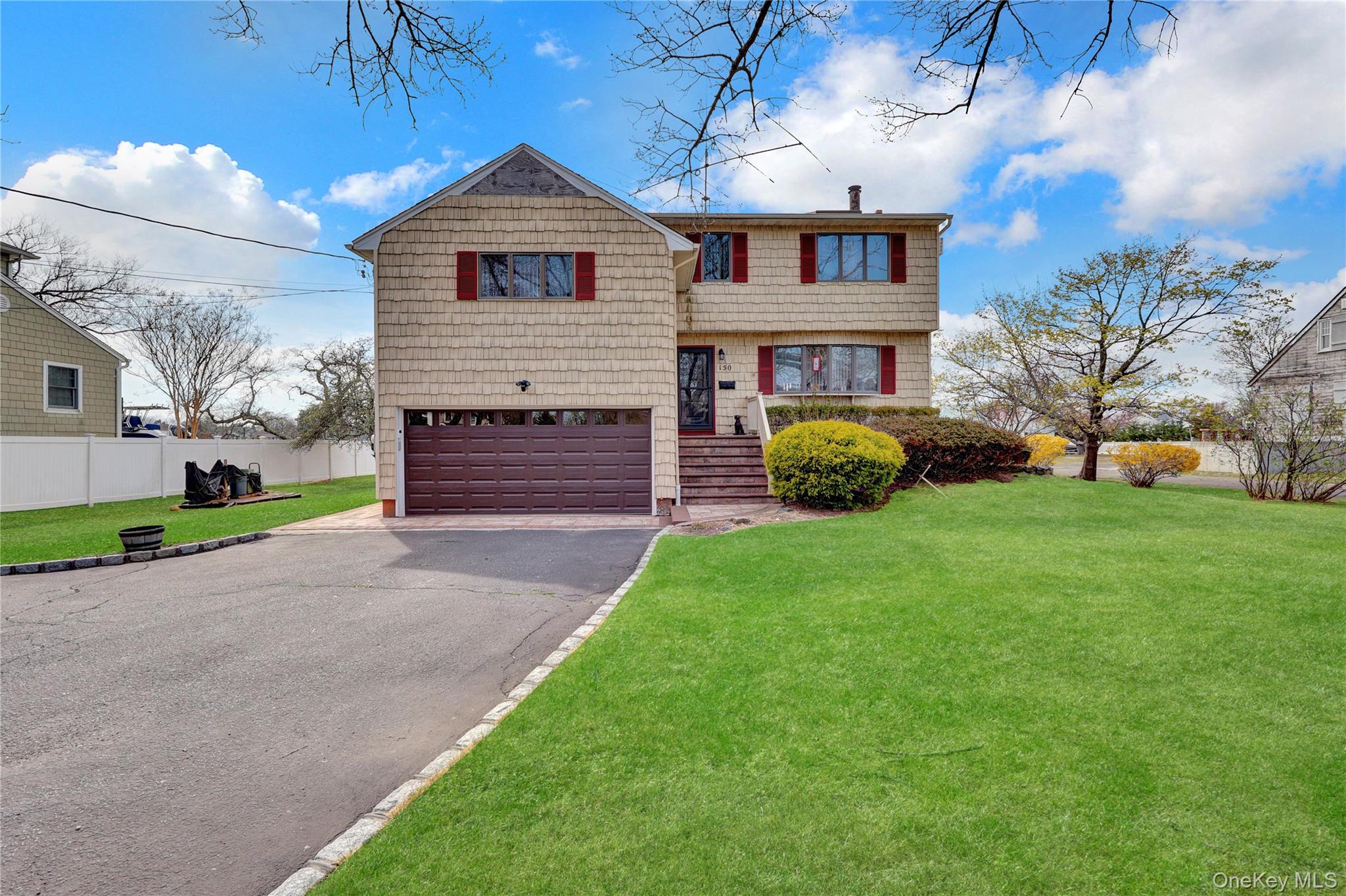 150 West Islip Road West Islip, NY 11795 - Photo 1 of 1 a front view of a house with a garden and entertaining space
