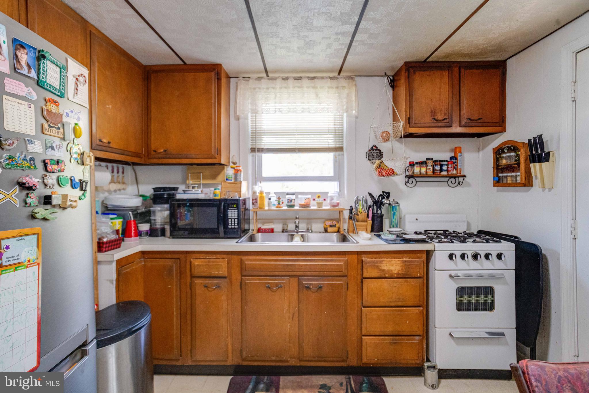 900 Renfrew Street Baltimore, MD 21221 - Photo 13 of 40 a kitchen with stainless steel appliances granite countertop a sink stove and refrigerator